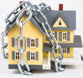 Photo of toy house wrapped in chains